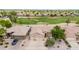 An aerial view reveals a well-maintained home on a golf course, showcasing its inviting curb appeal at 6141 S Bradshaw Way, Chandler, AZ 85249