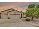 Inviting single-story home features a charming facade, complemented by a lush tree and a three-car garage at 6141 S Bradshaw Way, Chandler, AZ 85249
