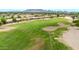 A stunning golf course features manicured fairways, sand hazards, and picturesque views for golfers of all levels at 6141 S Bradshaw Way, Chandler, AZ 85249