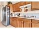 Functional kitchen with stainless steel refrigerator and wood cabinetry, offering ample storage at 6141 S Bradshaw Way, Chandler, AZ 85249