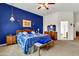 Comfortable main bedroom featuring a striking blue accent wall and ample natural light at 6141 S Bradshaw Way, Chandler, AZ 85249