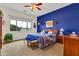 Comfortable main bedroom featuring a striking blue accent wall and ample natural light at 6141 S Bradshaw Way, Chandler, AZ 85249