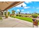 Covered patio with outdoor seating and beautiful backyard view of lush landscaping and golf course at 6141 S Bradshaw Way, Chandler, AZ 85249