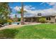 Expansive backyard with green grass, desert landscaping and a covered patio at 711 W El Alba Way, Chandler, AZ 85225