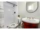 The bathroom features a sleek white tiled shower with a modern vanity and round mirror at 711 W El Alba Way, Chandler, AZ 85225