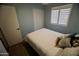 Comfortable bedroom with light blue walls, white trim and a large window at 711 W El Alba Way, Chandler, AZ 85225