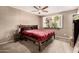 Comfortable bedroom featuring a ceiling fan, and a window with a decorative shelf for plants at 711 W El Alba Way, Chandler, AZ 85225