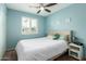 Bright bedroom with a ceiling fan and a window with white shutters that allow plenty of natural light at 711 W El Alba Way, Chandler, AZ 85225