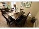 Dining room featuring a dark wood table, black chairs and views of the adjacent kitchen at 711 W El Alba Way, Chandler, AZ 85225