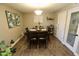 Cozy dining room featuring dark wood furniture, hardwood floors, and a bar cart at 711 W El Alba Way, Chandler, AZ 85225