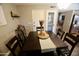 Relaxed dining room featuring a dark wood table and chairs, and a decorated bar cart at 711 W El Alba Way, Chandler, AZ 85225