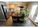 Kitchen with wood cabinets, stainless steel appliances, laminate counters, breakfast bar, and wood-look floors at 711 W El Alba Way, Chandler, AZ 85225