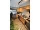 Kitchen boasts stainless steel appliances, wood cabinets, laminate counters and wood-look floors at 711 W El Alba Way, Chandler, AZ 85225