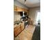 A well-lit kitchen showcases wood cabinets, granite countertops, stainless steel appliances and wood-look flooring at 711 W El Alba Way, Chandler, AZ 85225