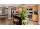 Bright kitchen with stainless steel appliances, dark granite island, and wood cabinets at 711 W El Alba Way, Chandler, AZ 85225