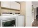 Functional laundry room with stacked washer and dryer and plenty of storage space with cabinets at 711 W El Alba Way, Chandler, AZ 85225