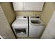 Clean and well-organized laundry room featuring a washer, dryer, and upper cabinets at 711 W El Alba Way, Chandler, AZ 85225