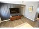 Stylish living room with dark accent wall, modern furniture, wood-look flooring, and ample natural light at 711 W El Alba Way, Chandler, AZ 85225