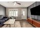Comfortable living room showcasing trendy furnishings, wood floors, and a ceiling fan at 711 W El Alba Way, Chandler, AZ 85225