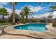 Beautiful backyard pool surrounded by desert landscaping and palm trees at 711 W El Alba Way, Chandler, AZ 85225