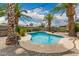 Backyard pool surrounded by palm trees and desert landscaping at 711 W El Alba Way, Chandler, AZ 85225