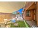 Inviting backyard oasis with covered patio, artificial turf, and gravel, perfect for outdoor entertaining at 7242 S 48Th Gln, Laveen, AZ 85339