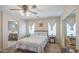 Well-lit main bedroom with a comfortable bed, side tables, and a mirrored closet at 7242 S 48Th Gln, Laveen, AZ 85339