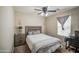 Cozy bedroom with a comfortable bed, modern nightstand, and a convenient desk area at 7242 S 48Th Gln, Laveen, AZ 85339