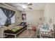 Bright and playful bedroom featuring a twin bed, crib, and decor, creating a cheerful space at 7242 S 48Th Gln, Laveen, AZ 85339