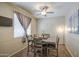 Dining room features a modern ceiling fan, table with chairs and natural light at 7242 S 48Th Gln, Laveen, AZ 85339