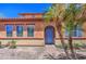 Charming home featuring a blue front door, lush palm trees and desert landscaping at 7242 S 48Th Gln, Laveen, AZ 85339