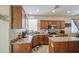 Well-lit kitchen with stainless appliances, tile floors, and ample wooden cabinets at 7242 S 48Th Gln, Laveen, AZ 85339