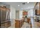 Bright kitchen featuring stainless steel appliances, tiled floor, and an island at 7242 S 48Th Gln, Laveen, AZ 85339