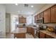 Well-lit kitchen featuring stainless steel appliances and plenty of wooden cabinet space at 7242 S 48Th Gln, Laveen, AZ 85339