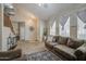 Spacious living room with soaring ceilings, lots of natural light, and a comfortable seating area at 7242 S 48Th Gln, Laveen, AZ 85339