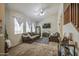 Cozy living room with plush seating, carpet flooring, and bright, natural light at 7242 S 48Th Gln, Laveen, AZ 85339
