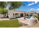 Beautiful backyard with swimming pool, outdoor seating, and lush landscaping, ideal for relaxing at 7492 E Buteo Dr, Scottsdale, AZ 85255