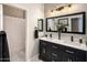 Bright bathroom features double sinks, black fixtures, and a shower with neutral decor at 7492 E Buteo Dr, Scottsdale, AZ 85255