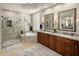 Luxurious bathroom featuring a glass-enclosed shower, soaking tub, double vanity, and elegant finishes at 7492 E Buteo Dr, Scottsdale, AZ 85255