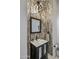 Stylish powder room featuring a modern vanity, decorative tile wall, and contemporary lighting fixture at 7492 E Buteo Dr, Scottsdale, AZ 85255