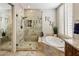 Modern bathroom with a glass shower, a soaking tub and stone countertops at 7492 E Buteo Dr, Scottsdale, AZ 85255