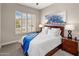 Bedroom features an oversized window and a comfortable queen size bed with bright blue accents at 7492 E Buteo Dr, Scottsdale, AZ 85255