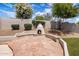 Backyard fireplace with stone patio perfect for relaxing and entertaining outdoors at 7492 E Buteo Dr, Scottsdale, AZ 85255