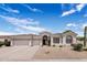 Charming single-story home with a three-car garage, desert landscaping and a tile roof at 7492 E Buteo Dr, Scottsdale, AZ 85255