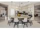 Kitchen island with granite countertops, white cabinets and pendant lighting with seating at 7492 E Buteo Dr, Scottsdale, AZ 85255