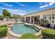 Inviting backyard pool features rock detail and lush landscaping, perfect for outdoor enjoyment at 7492 E Buteo Dr, Scottsdale, AZ 85255