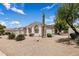 A view of the side of a home with desert landscaping including a Saguaro Cactus at 7492 E Buteo Dr, Scottsdale, AZ 85255