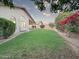 Serene backyard with lush green lawn and vibrant bougainvillea bushes at 8319 E Plata Ave, Mesa, AZ 85212