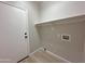 Efficient laundry room featuring neutral tones, a storage shelf, and hookups for appliances at 8319 E Plata Ave, Mesa, AZ 85212