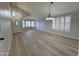 Bright living room showcasing light wood floors, plantation shutters, and stylish light fixtures at 8319 E Plata Ave, Mesa, AZ 85212